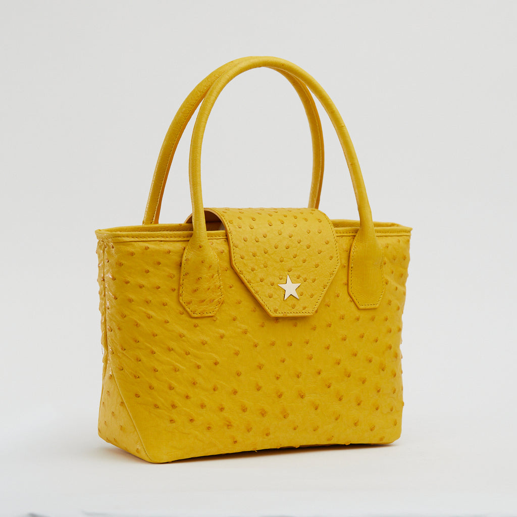 Ostrich leather handbags available in pink, yellow, brown, black and more